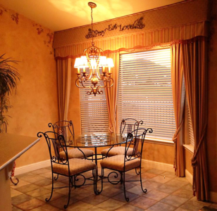 French Design: Cornice Box w/Metal overlay Lettering, beaded scallop, and coordinating Side Panels w/Tie Backs. French style light fixture and faux painted wall w/hand painted grape vines complete the look. Hunter Douglas Faux Wood Blinds