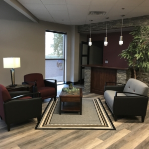Custom Made Counter and furniture, w/ rock wall, vinyl plank flooring, lighting & painted walls. Hunter Douglas Screen Shades for privacy.