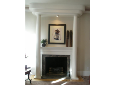 Art Deco Style: Fireplace with granite slab and inlaid wood border.