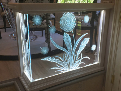 Custom Made, Carved Glass, Back Lit Stair Rail with Silestone Handrail for step down from dining room into sunken living room.