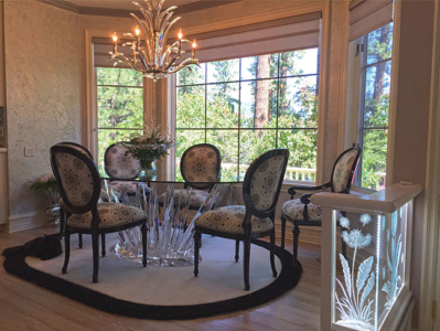 Crystal Chandelier with Custom Made Dining Room Table and Area Rug, Re-upholstered Chairs painted Black. Custom Wall Finish, Grey Roman Shades complete the look, Cat is a real novelty!