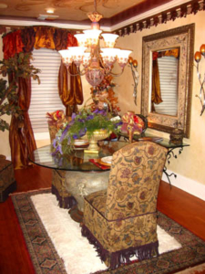 Traditional with a FLAIR: Custom made silk window treatments with silhouettes, area rug and hand painted mirror. Mural ceiling & faux painted walls, Lion head pedestal table with tapestry chairs and fringe, chandelier w/ ceiling medallion. Floor features wood border inlays and wood rose. Exclusive antique wallpaper border, dated between 1890-1910, is authenticated by the Smithsonian institute.