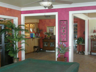 A menagerie of wonderful vibrant colors. Walls are faux finished in bright shades of pink, orange with deep red highlights, and greens.