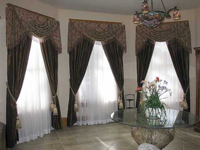 Swags & Cascades with Long Side Panels and Tassel Tiebacks. Beaded Trim compliments the Tiffany Style Chandelier.