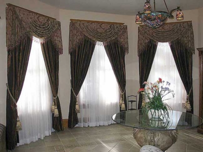 Swags & Cascades with Long Side Panels and Tassel Tiebacks. Beaded Trim compliments the Tiffany Style Chandelier.