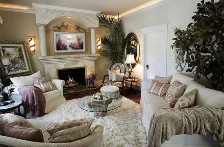 110 year old home. Faux painted Fireplace re-model with Columns, Travertine Tile, Granite Hearth, Framed Flat Screen TV. Recessed lighting, wall sconces and indirect lighting, wall sculpture, area rug, throw pillows and neutral furniture complete the look.